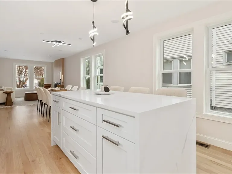 Luxury meets function: The expansive granite island offers deep storage cabinets and serves as the perfect breakfast bar or meal-prep station.