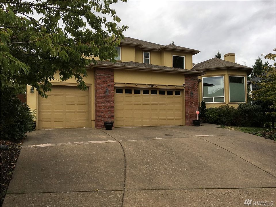 3 car garage, home is located on a corner lot next to the greenspace