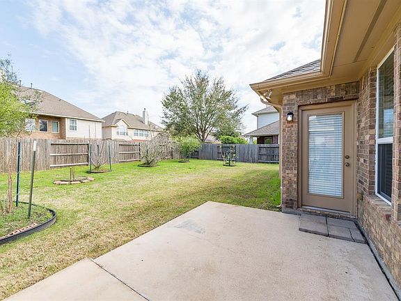 Peaceful back yard has several fruit trees!