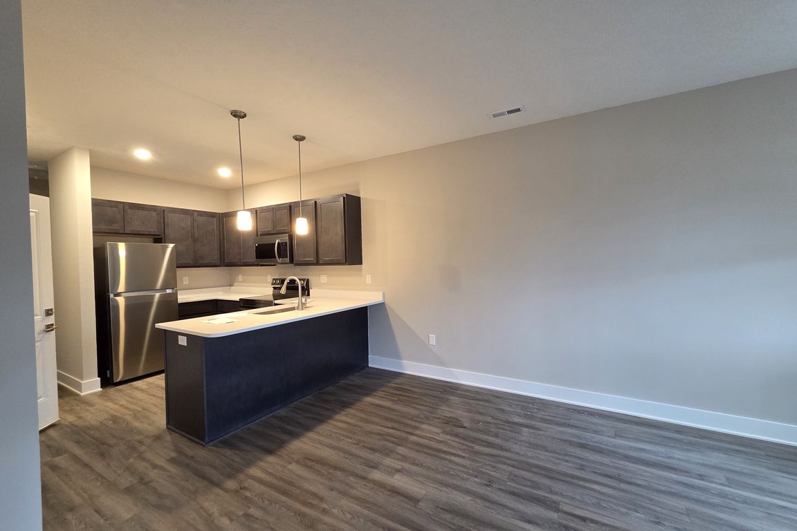 Townhome kitchen featuring new appliances.