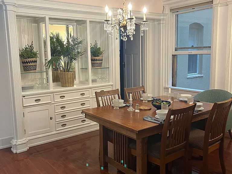 Dining room with vintage built-in and chandelier.