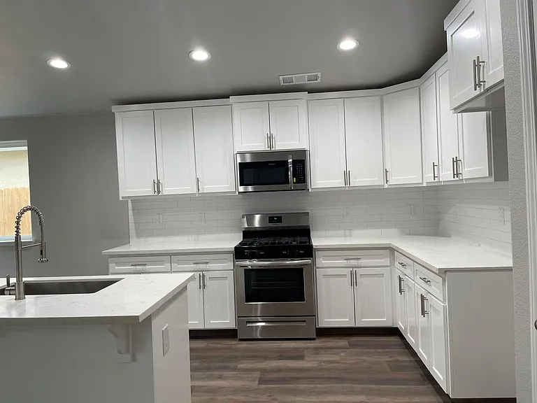 Kitchen with island and brand new range, microwave and dishwasher