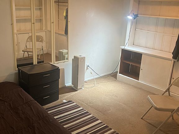 BDRM twin bed on the wall, mirrors, clothing unit