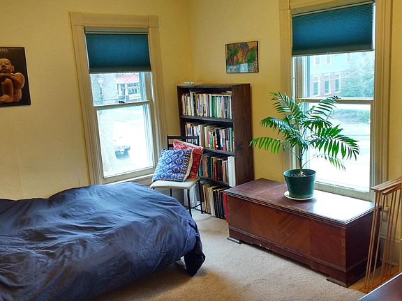 Front bedroom facing the street, with full-size futon and desk. There is a closet out of view to the left.
