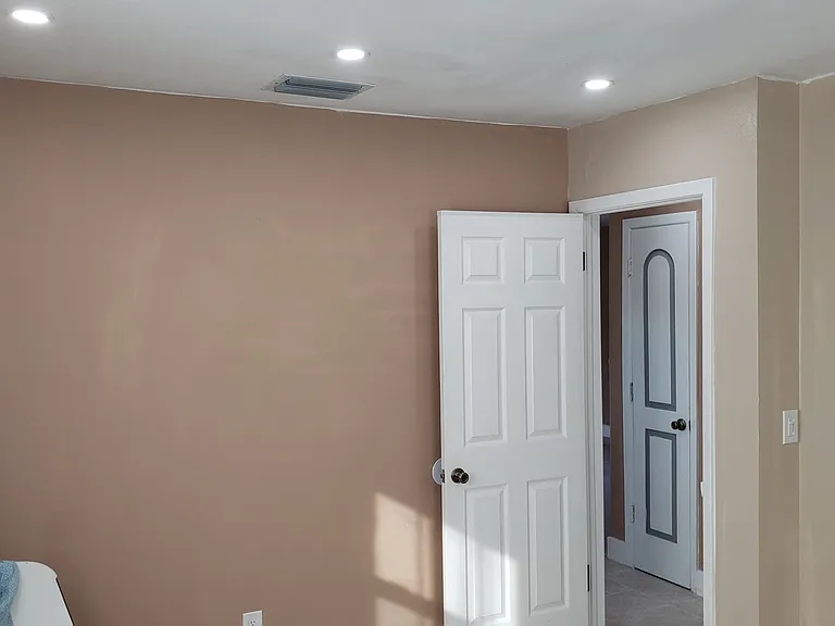 Bedroom One Looking at Small Closet (Blue/Gray Door) in Hallway.
