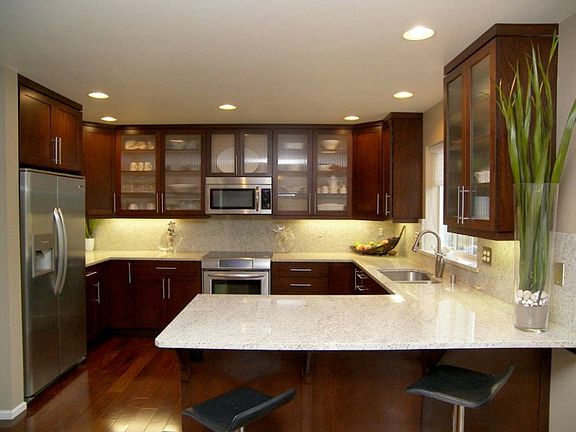 The kitchen is done in cherry cupboards, granite counter tops and stainless appliances. Brushed pewter door pulls bring the finishing touches to this remarkable room and you will LOVE being here. You can see plenty of workspace for two and it opens up into a dining area and living room. It's also just a few steps from the back yard which is ready for entertaining.
