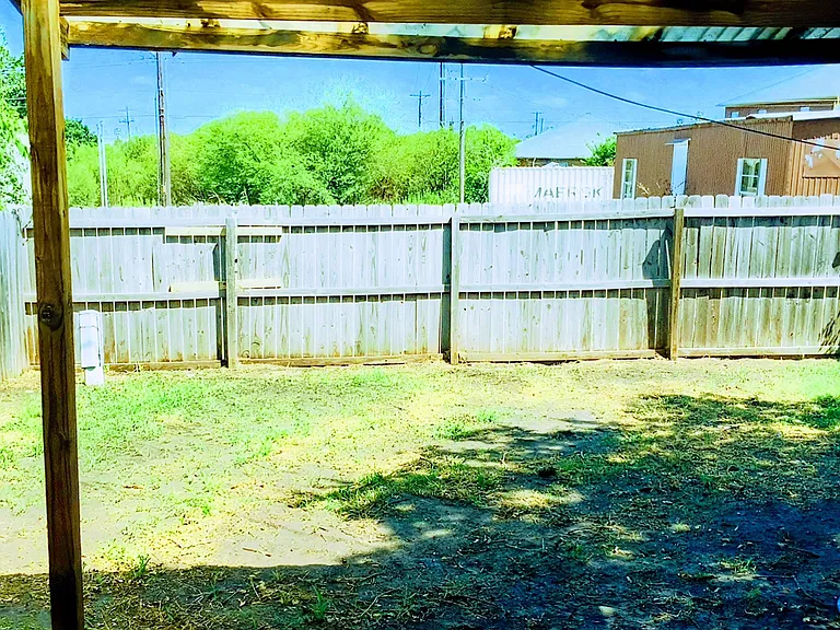 Covered awning out the back door. with private fencing