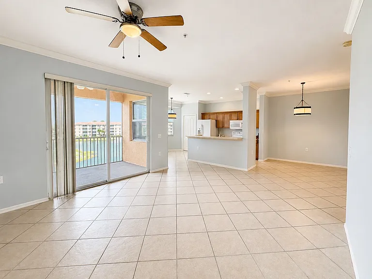 Bright open-concept living with lake views and screened lanai access