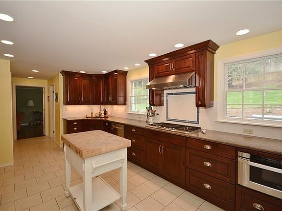 The kitchen features gorgeous cherry cabinetry