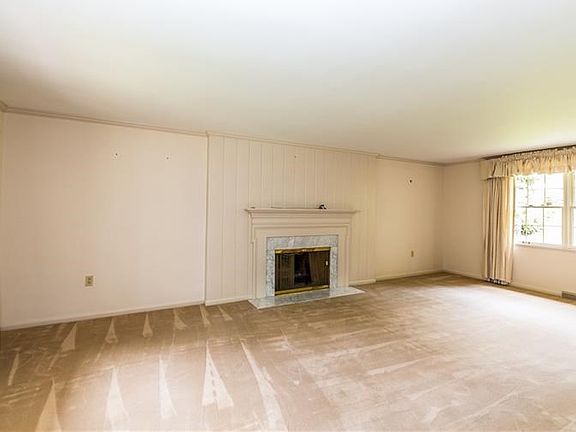 Living room - hardwood flooring under carpet & gas fireplace