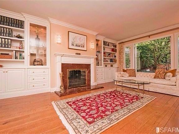 Grand & inviting living room with French doors leading to the terrace.