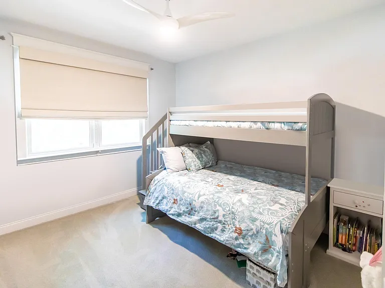 Bedroom two has beautiful large windows overlooking the trees in front of the house.