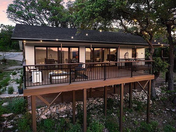Nestled in between live oak trees, enjoy the views from the large deck.