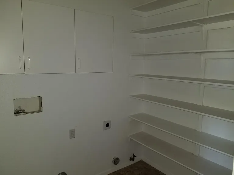 Laundry is downstairs just off kitcen has shelves to store misc. or as spill over food storage.