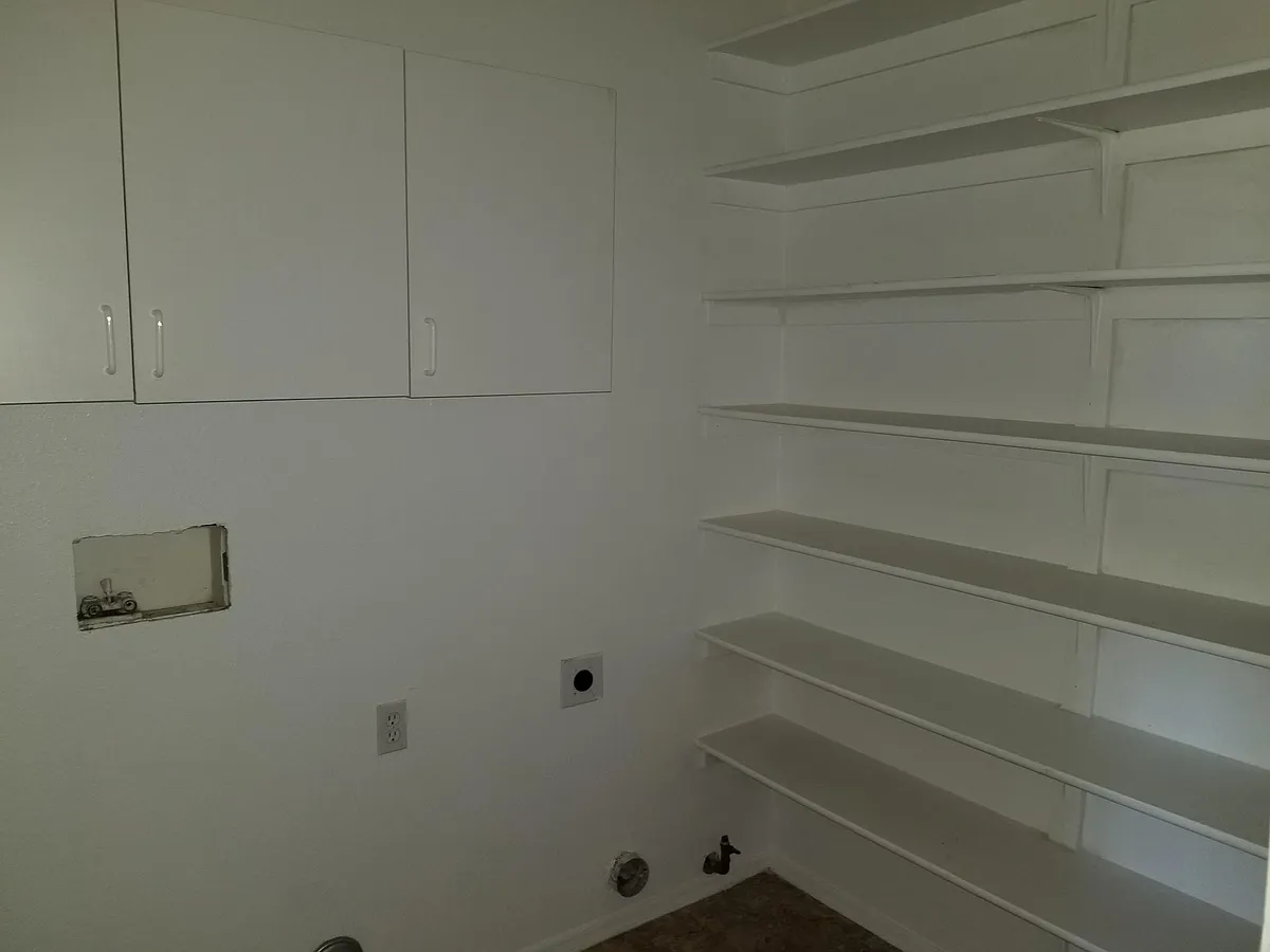 Laundry is downstairs just off kitcen has shelves to store misc. or as spill over food storage. - 7706 W Desert Paintbrush Ct