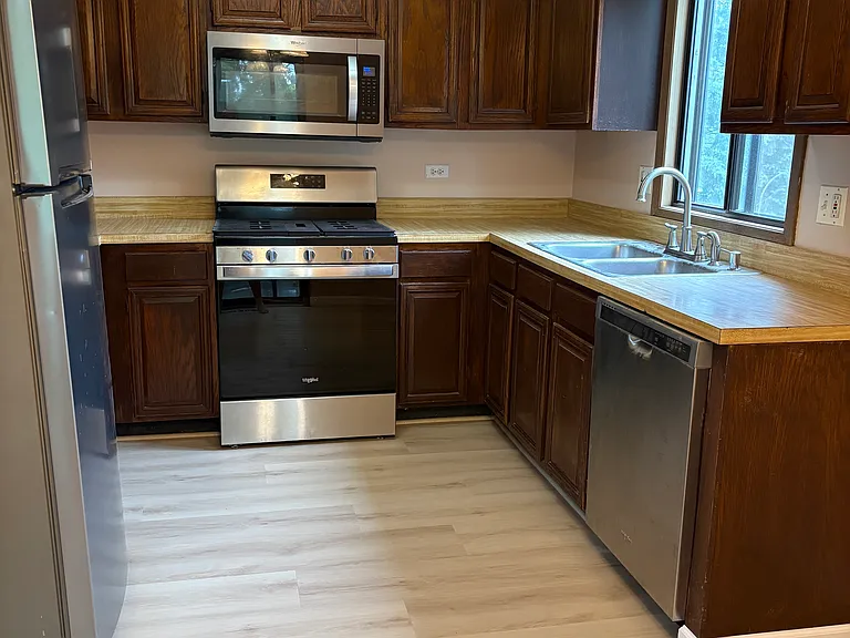 Kitchen with New Flooring and Newer SS Appliances