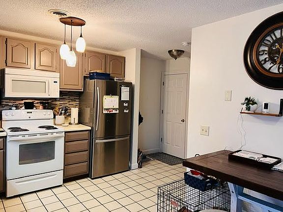Kitchen when standing in dinette; door to full basement, hallway to living room