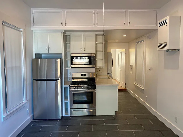 FULLY UPGRADED KITCHEN WITH ALL NEW SHAKER-STYLE CABINETS, NEW EXPANSIVE QUARTZ COUNTERTOPS AND FULL SUITE OF TOP BRAND STAINLESS STEEL APPLIANCES