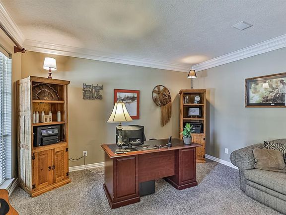 Spacious den to the left of the entryway at the front of the home. This room can also be utilized as an office/study. Nice views of the beautiful front yard and greenspace.