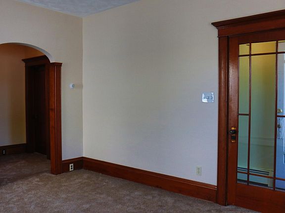 Front door to the left. Arch leads to kitchen, bedroom and bathroom.