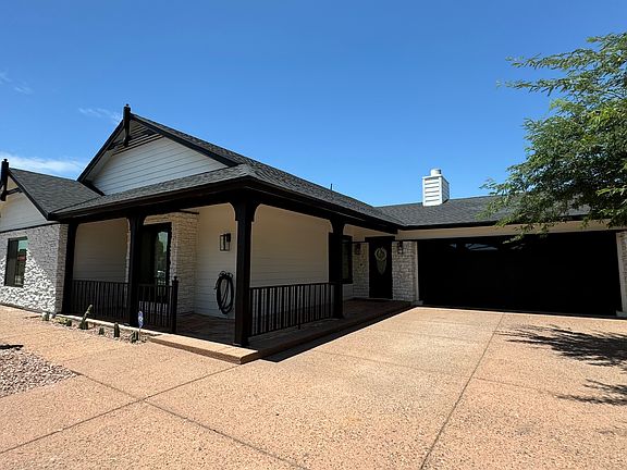 EXTERIOR. Street view. Property offers a two-car garage, covered porch and ample driveway.