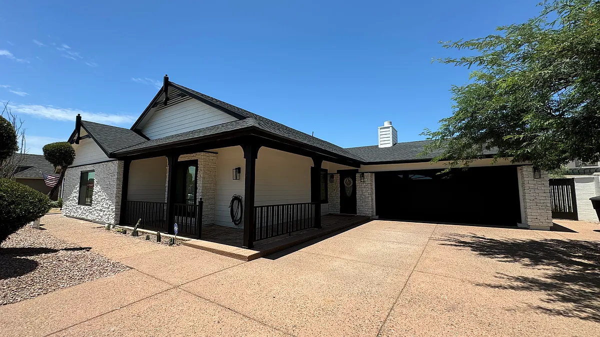 EXTERIOR. Street view. Property offers a two-car garage, covered porch and ample driveway. - 8014 E Tuckey Ln