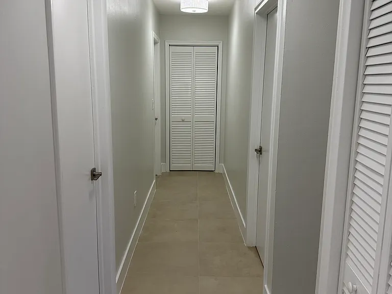 Hallway into bedrooms with linen closet at end