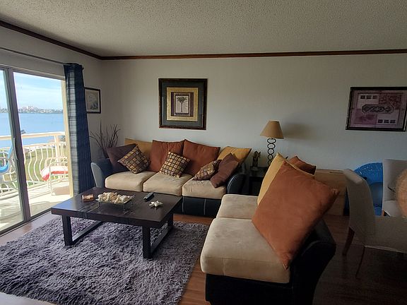 Living room with direct water views & outside balcony.