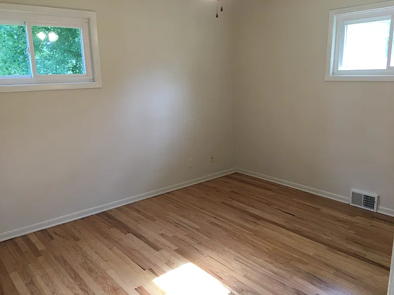 Second bedroom with refinished oak hardwood floors.