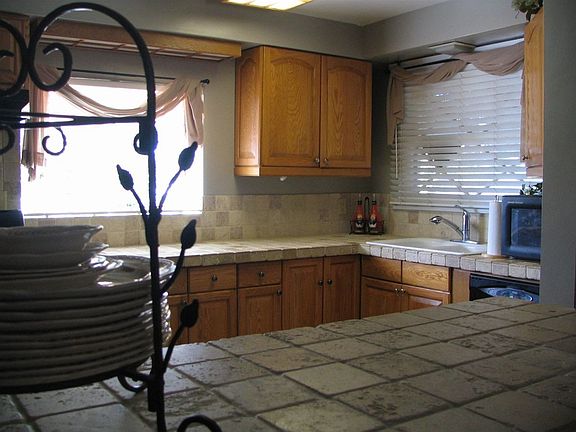 Kitchen w/custom tile countertops, tile floor, all new black appliances