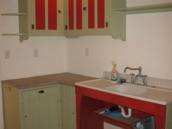 This is an old photo of the kitchen - faucet was replaced this year. Concrete countertops, wood floors and reclaimed wood ceilings.