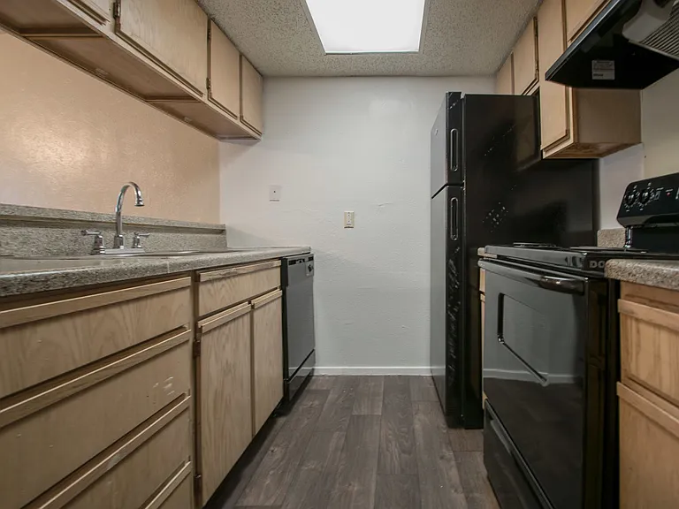 Huntington Townhomes with Brown Cabinets and Black Appliances