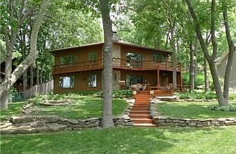 This custom built, contemporary lake front home has 80 ft of shorline!