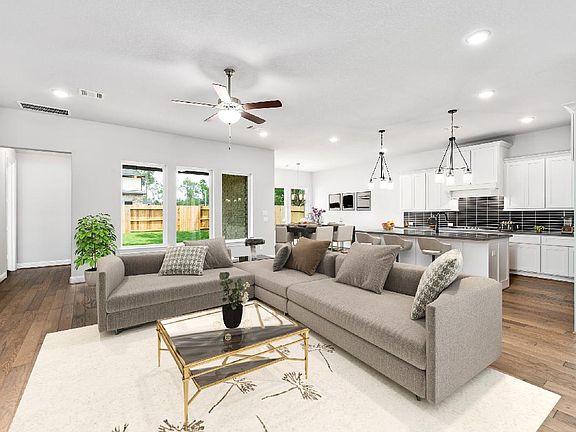 Spacious great room opens to kitchen, virtually staged for demonstration