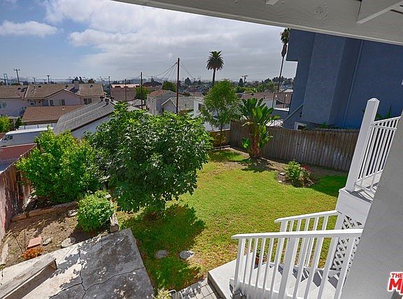 Grassy fenced in back yard from deck - awesome views!