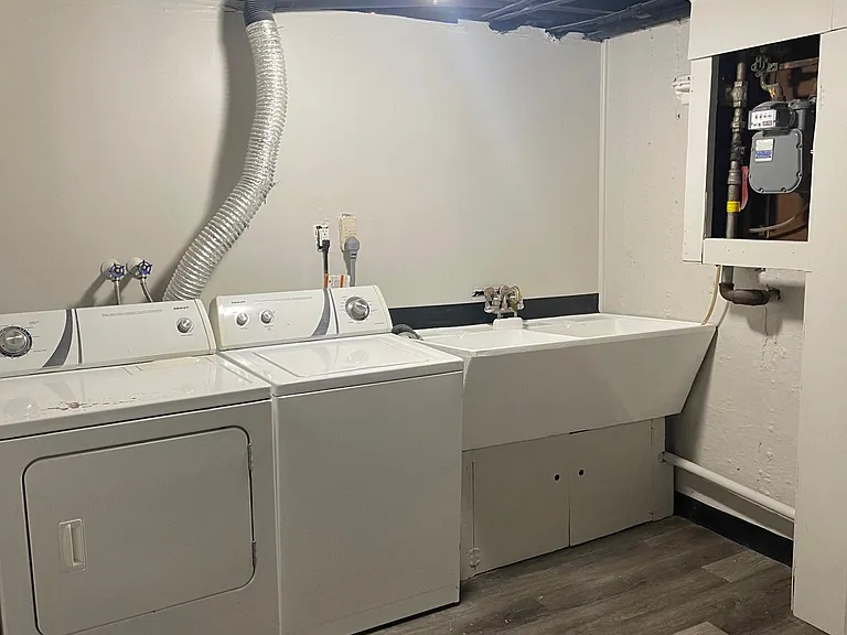 Separate laundry area in basement with door.