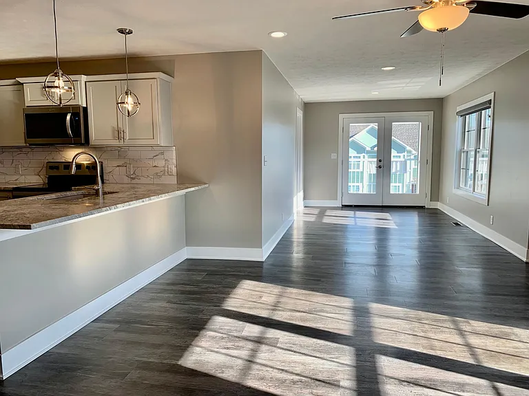 Living room leads to the double doors for the covered deck
