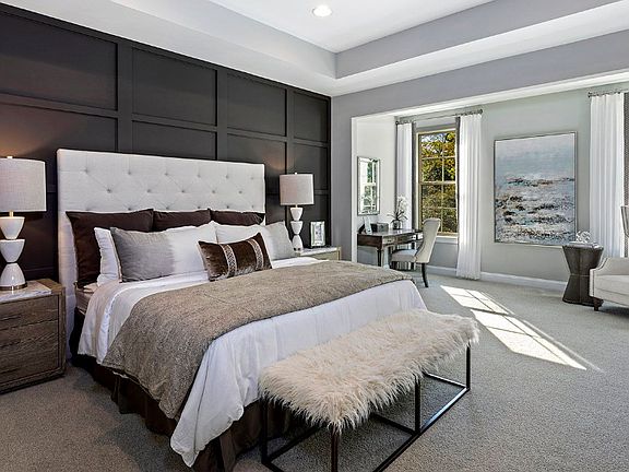 Owner s suite with tray ceiling and two large windows in a DRB Homes Whitaker II model home.