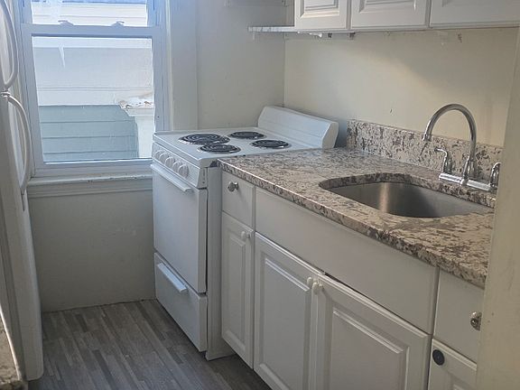 Galley kitchen. Granite counter. Undermount sink