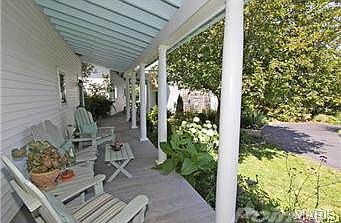 Front porch with sitting area.  Fir flooring and outside sound s