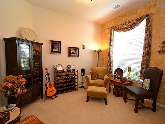 Double doors open to the study accented by raised ceilings.