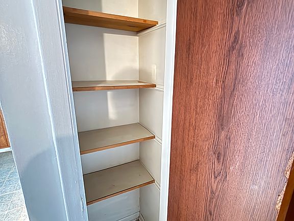 Closet by front door with shelves for storage