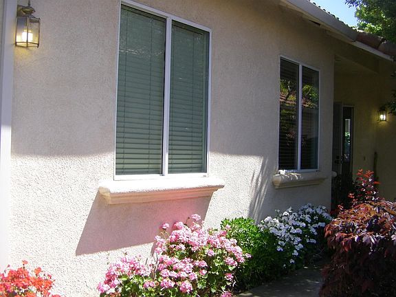 Flowers galore enhance the lovely entrance into the home.