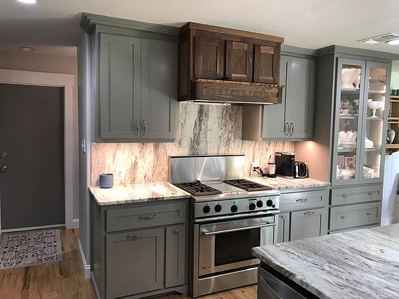Under cabinet lighting, glass cabinet with accent lighting. 36" gas range, convection oven, stainless steele griddle, powerful vent hood. All lower cabinets have custom oull outs for instant organization.