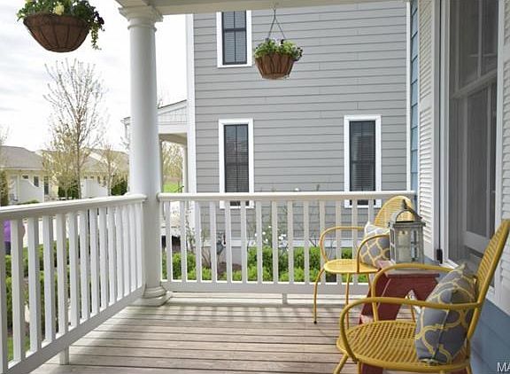Front porch with columns and railing.