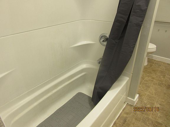 SHOWER AND TUB IN BIG BATHROOM.