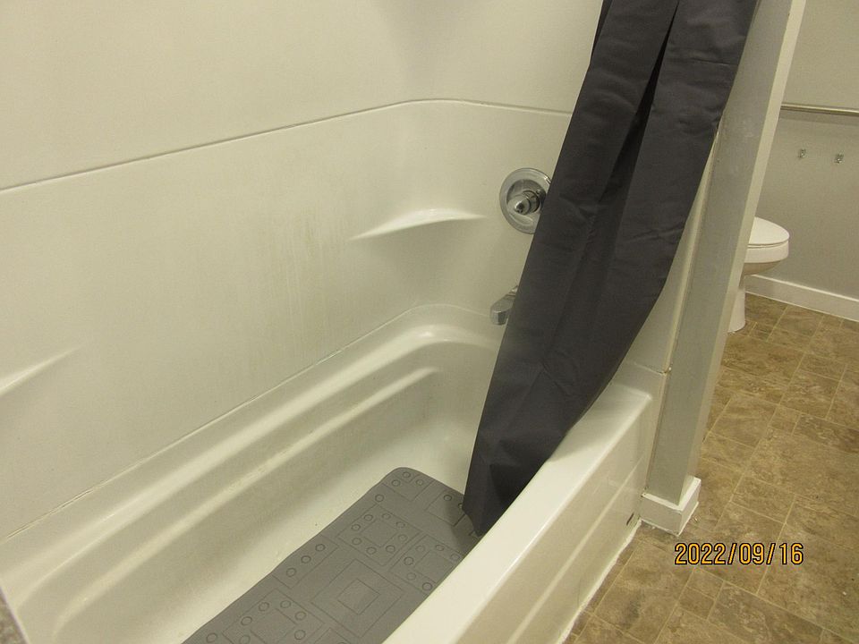 SHOWER AND TUB IN BIG BATHROOM.