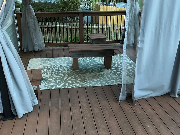 Composite deck with gazebo, enclosure includes mosquito net and or full opaque closure for privacy