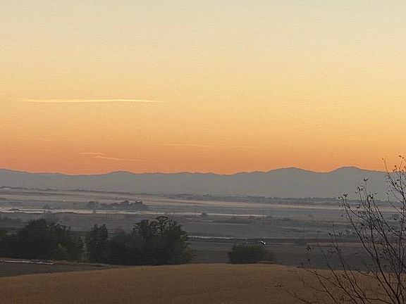 Sunrise from living room and front bedroom window. Antrim Drive runs along the rim of the escarpment in Greenleaf. Lovely Boise valley view.