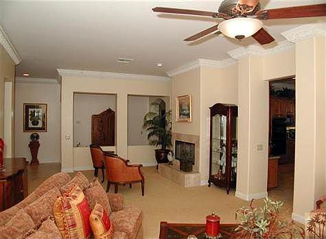 Living Room with gas fireplace and doors leading to pool area.
